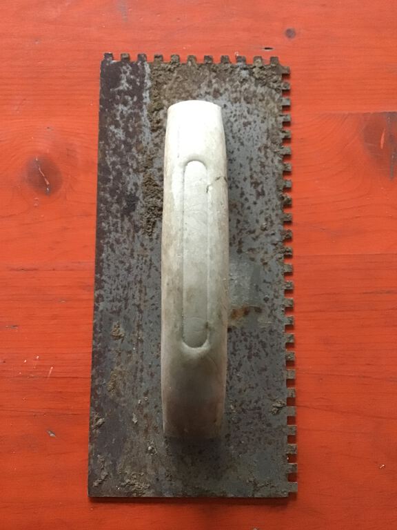 Notched Trowel with white plastic handle