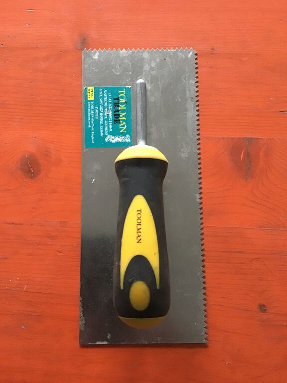 V-notched Trowel with yellow and black soft grip handle